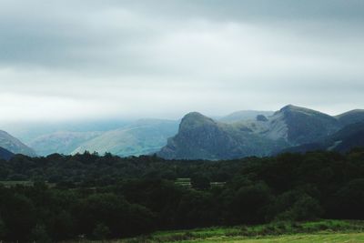 Scenic view of mountains against cloudy sky