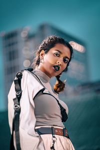 Portrait of young woman standing outdoors