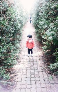 Full length of woman walking on footpath