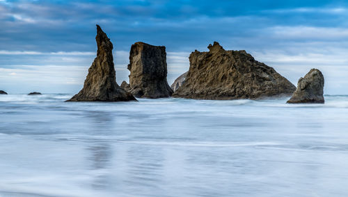 Panoramic view of rocks in sea against sky