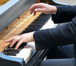 Midsection of man playing piano