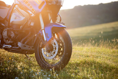 Closeup detail of a motorcycle front wheel in sunset light