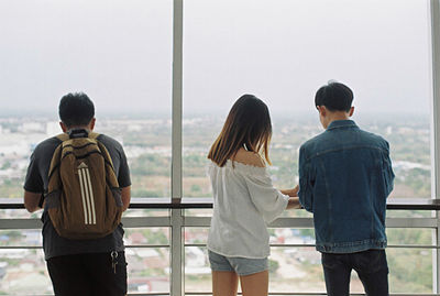 Rear view of two people standing outdoors