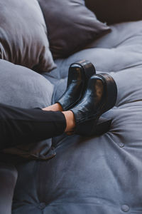 Low section of man relaxing on bed