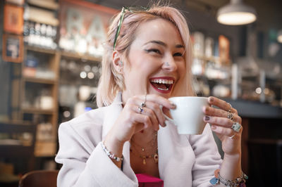 Young woman is drinking coffee in a cafe.