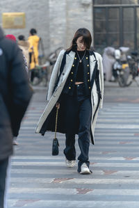 Low section of woman walking on street