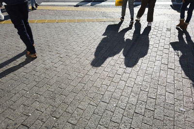 Low section of people walking on footpath