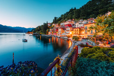 Village of varenna on lake como at sunset with illuminated houses