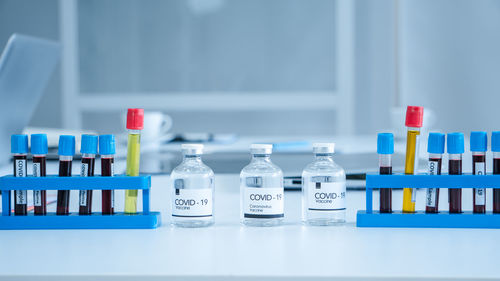 Close-up of multi colored bottles on table