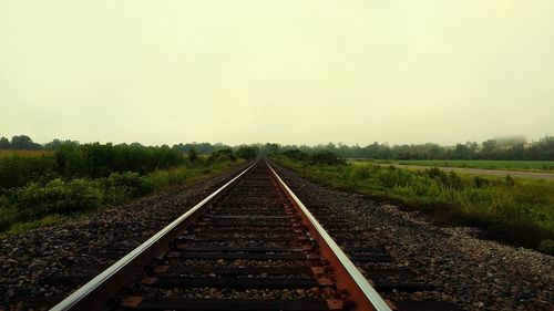 Empty railroad track at sunset