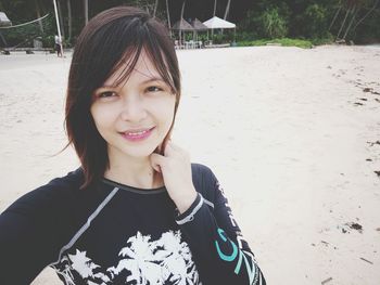 Portrait of smiling young woman on beach