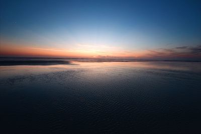 Scenic view of sea against sky at sunset