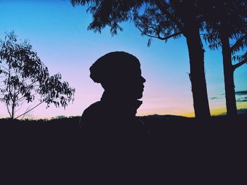 Silhouette man against clear sky during sunset