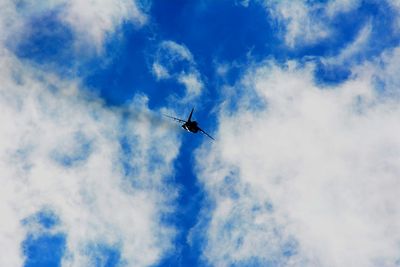 Low angle view of airplane flying in sky