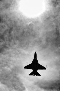 Low angle view of silhouette airplane against sky