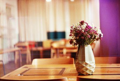 Close-up of flower vase on table in restaurant