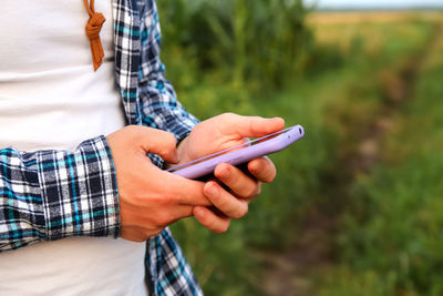Midsection of woman using mobile phone