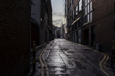 Narrow alley amidst buildings in city