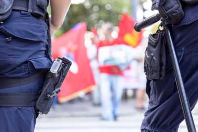 Police officers on duty during street protest, blurred protester in the background