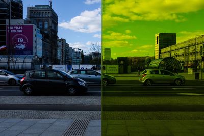 Cars on road in city against sky