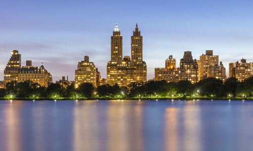 Illuminated buildings in city at waterfront