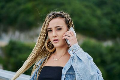 Portrait of a beautiful young woman standing outdoors