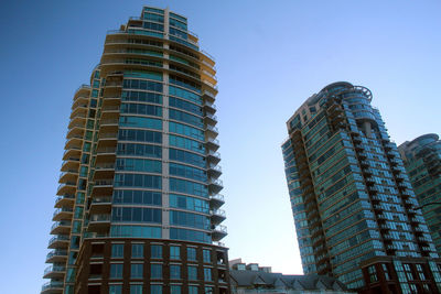 Low angle view of skyscrapers against clear sky