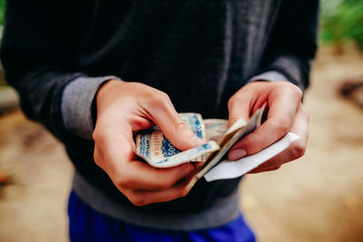 Close-up of hand holding money 