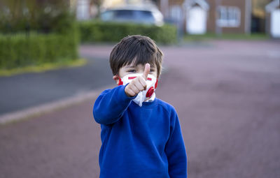 Portrait of boy standing on street