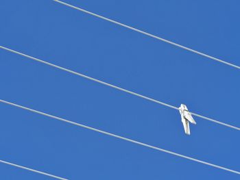 Low angle view of clothespin hanging on rope