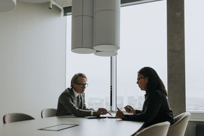 Business colleagues planning strategy in board room during meeting