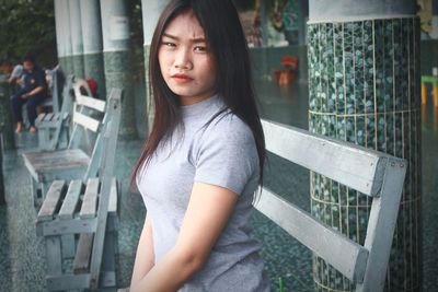 Portrait of beautiful woman sitting on bench