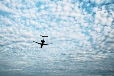 Low angle view of airplane flying in sky