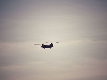 Low angle view of silhouette airplane against sky during sunset