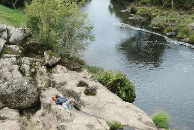 High angle view of people on rock by river