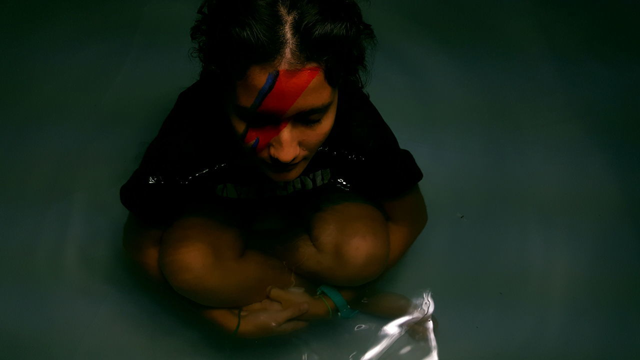 CLOSE-UP OF YOUNG WOMAN WITH WATER IN HAIR