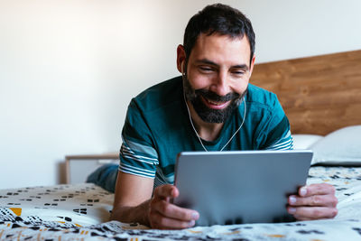 Young man using mobile phone at home