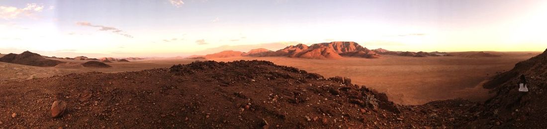 Panoramic view of desert against sky during sunset