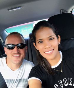 Portrait of smiling young woman in car