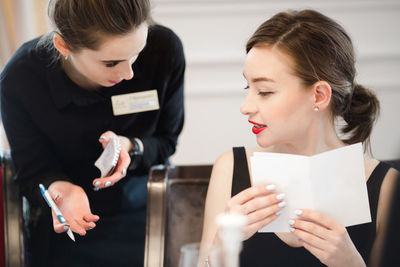 Woman making an order from the waitress menu