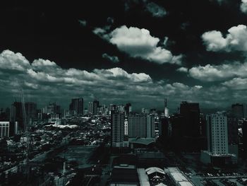 View of cityscape against cloudy sky