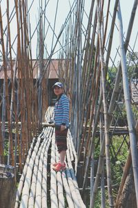 Full length side view of woman standing on bamboos