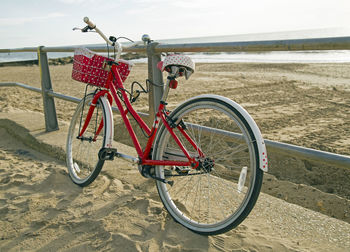 Bicycle on beach against sky