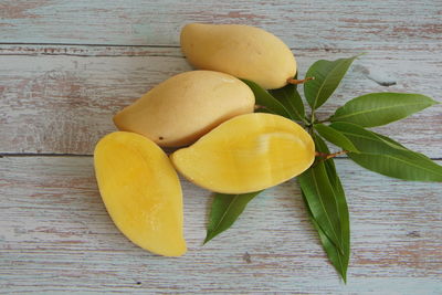 Mango fruits isolated on wooden background