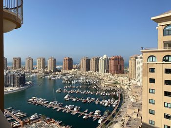 Aerial view of pearl qatar city buildings against blue sky