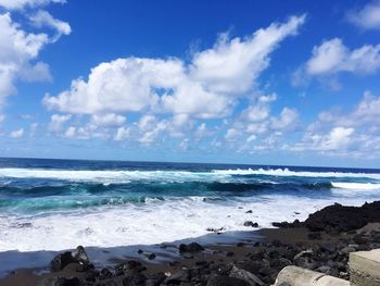 Scenic view of sea against blue sky