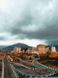 Panoramic view of city against cloudy sky