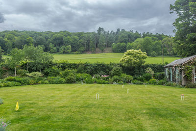 Scenic view of golf course against sky