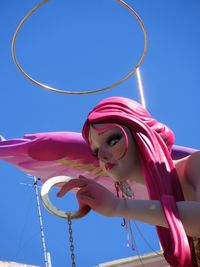 Low angle view of sculpture against clear blue sky