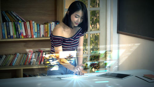 Digital composite image of woman using computer at table